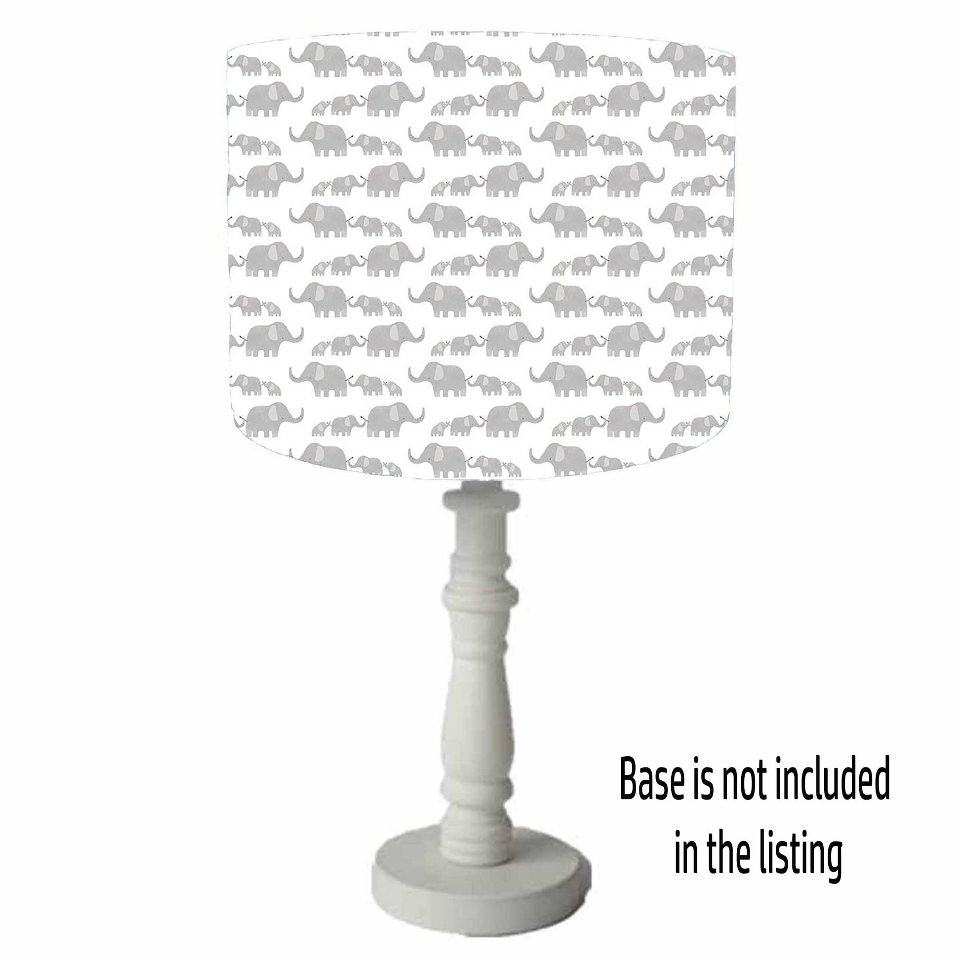 Safari themed drum lampshade with parent and baby elephant in grey on a white background. Table lamp view