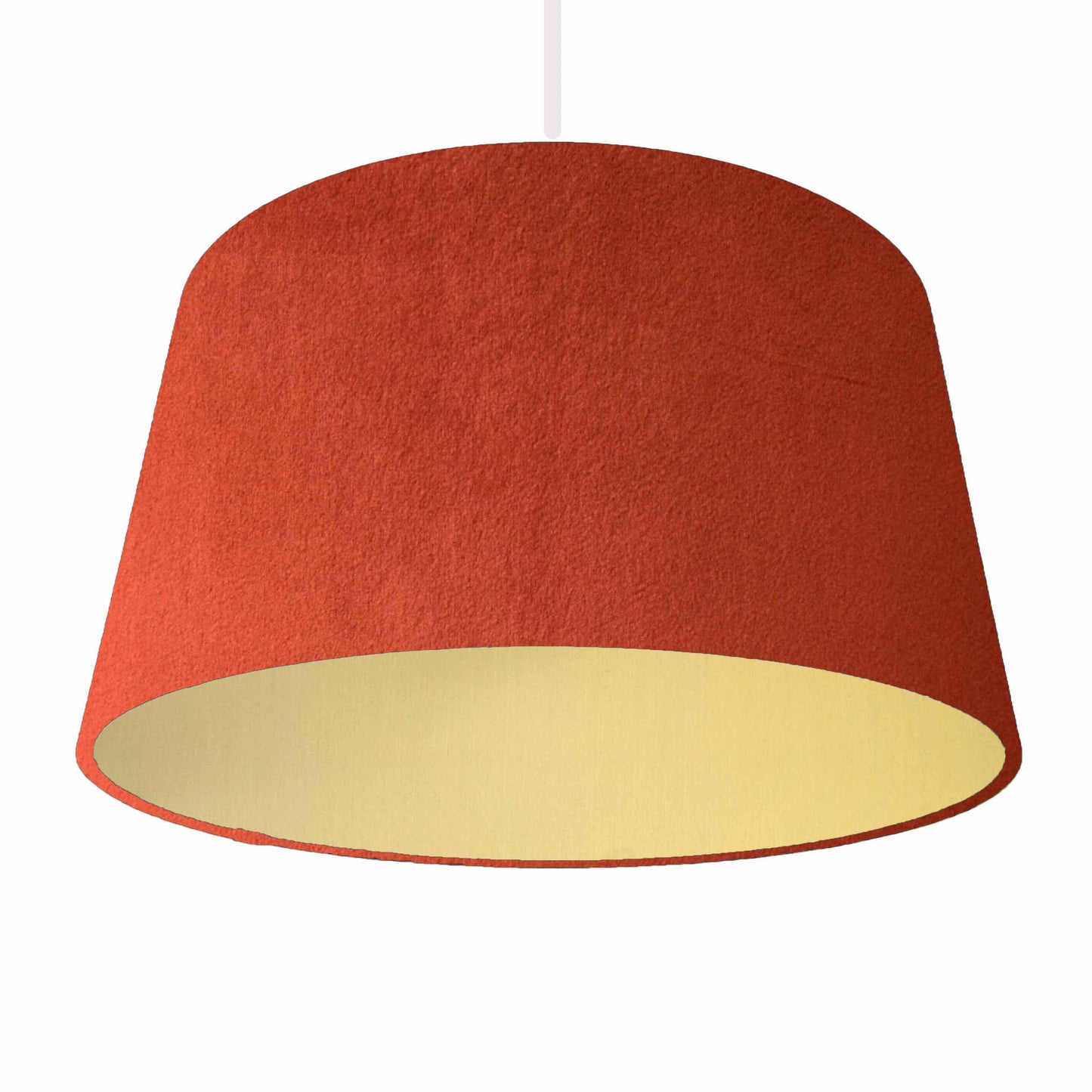 Orange velvet drum lampshade, with brushed gold lining. Hanging from ceiling light fixture view.