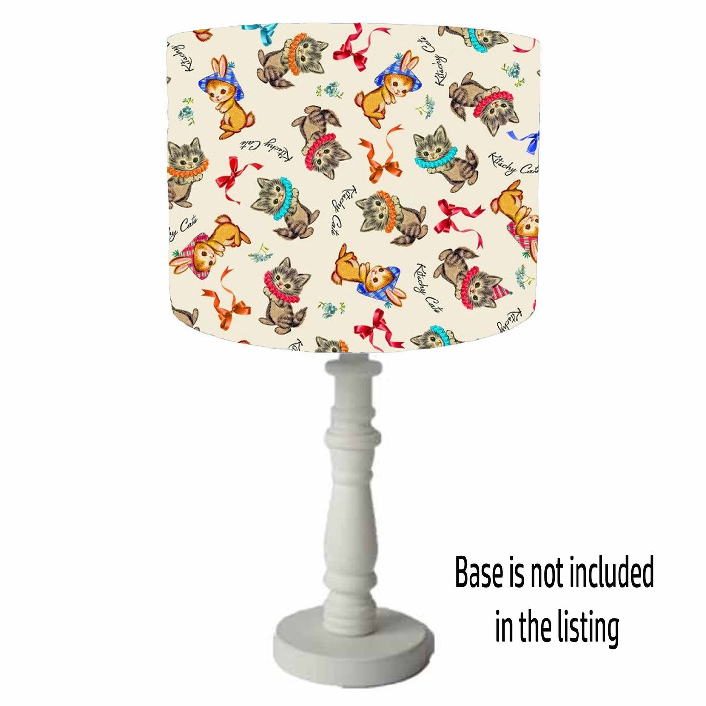 Lamp with colourful fun cat patterned shade on a cream background