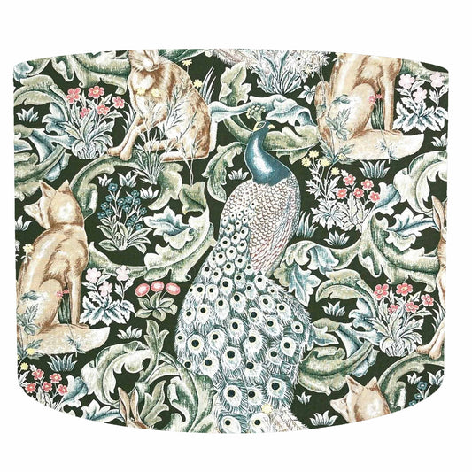 Decorative drum lampshade with peacock, fox, and floral design on a green background