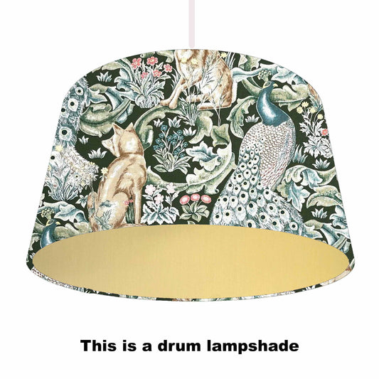 Decorative drum lampshade with nature-themed design on a green background and made with a gold coloured lining.