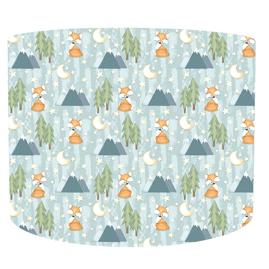 Patterned fabric with foxes, trees, and mountains on a light blue background