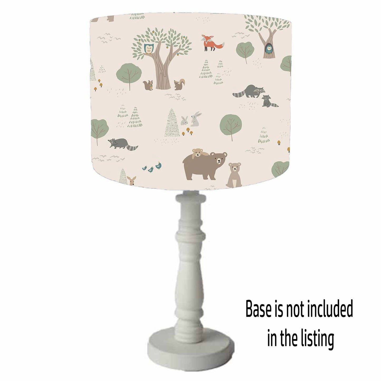 Lamp with a forest-themed table lamp shade on a cream background