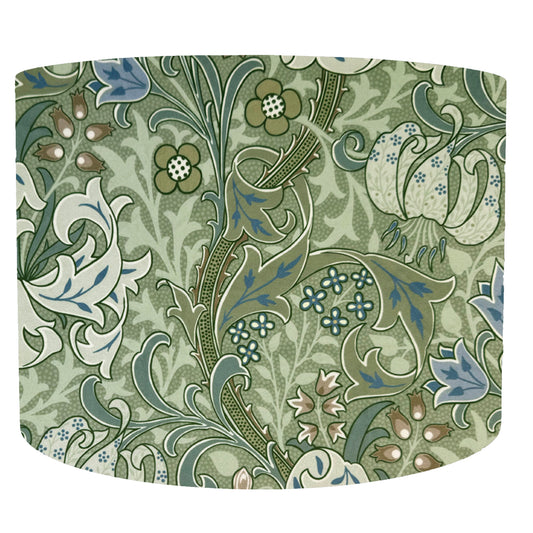 Botanical William Morris drum lampshade with a floral pattern in green and white on a white background