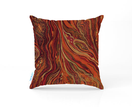 Decorative pillow with a swirling pattern in shades of red and orange on a white background